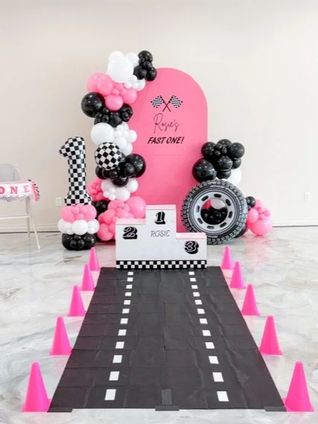 Race car themed balloon backdrop setup for birthday party