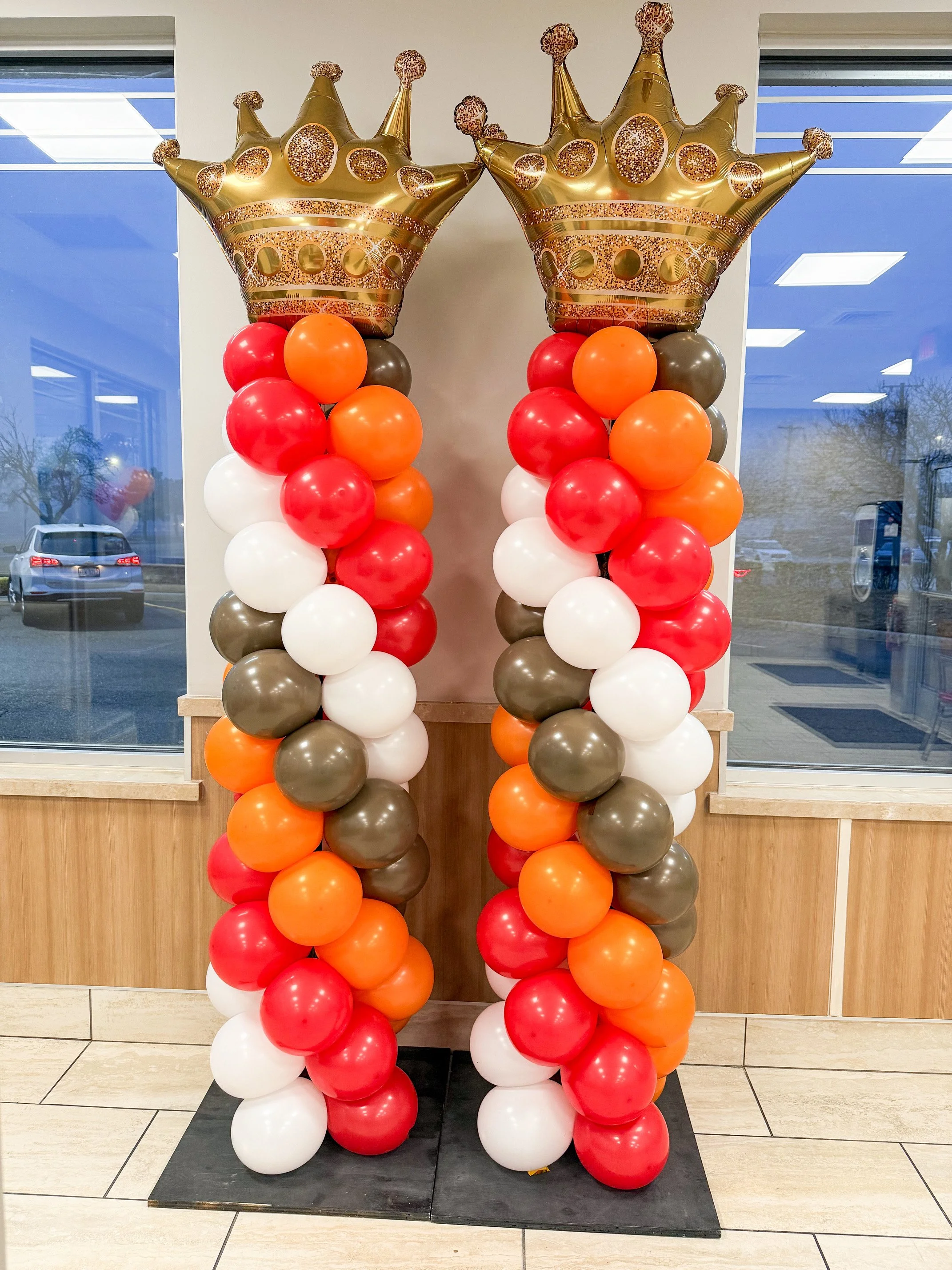 Custom balloon columns with crown toppers for grand opening event in Metro Detroit (Royal Oak)