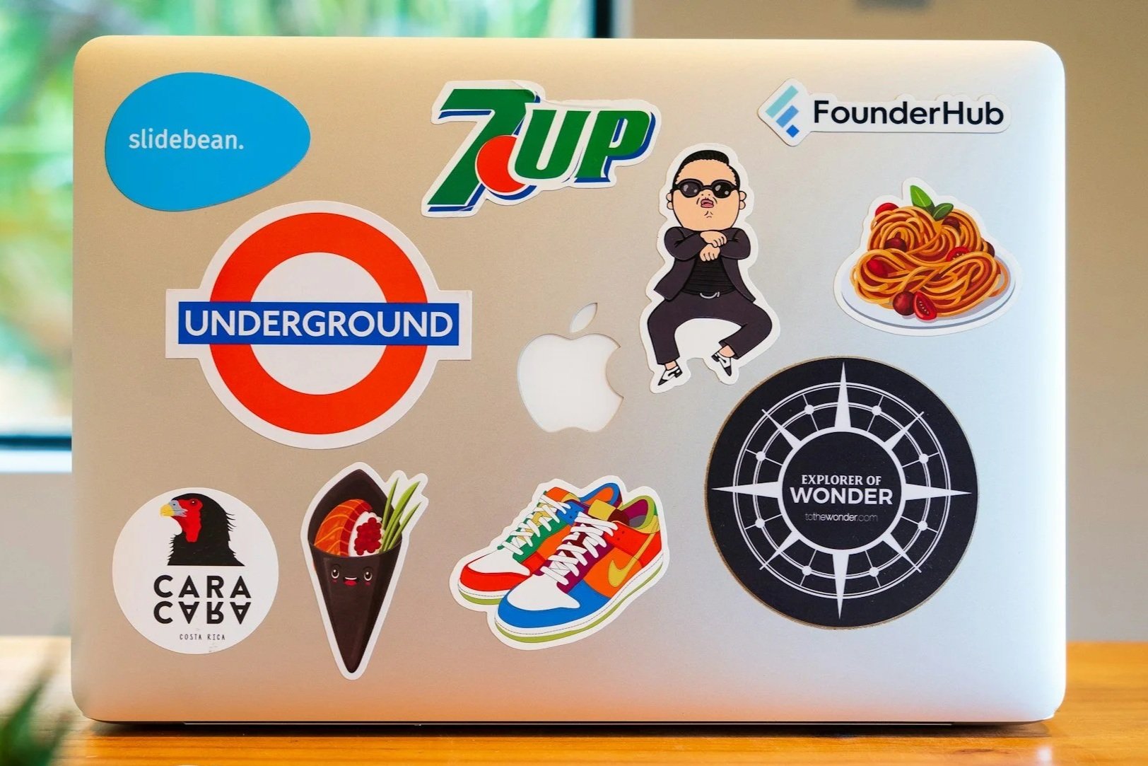 A laptop covered with various stickers of logos and phrases.