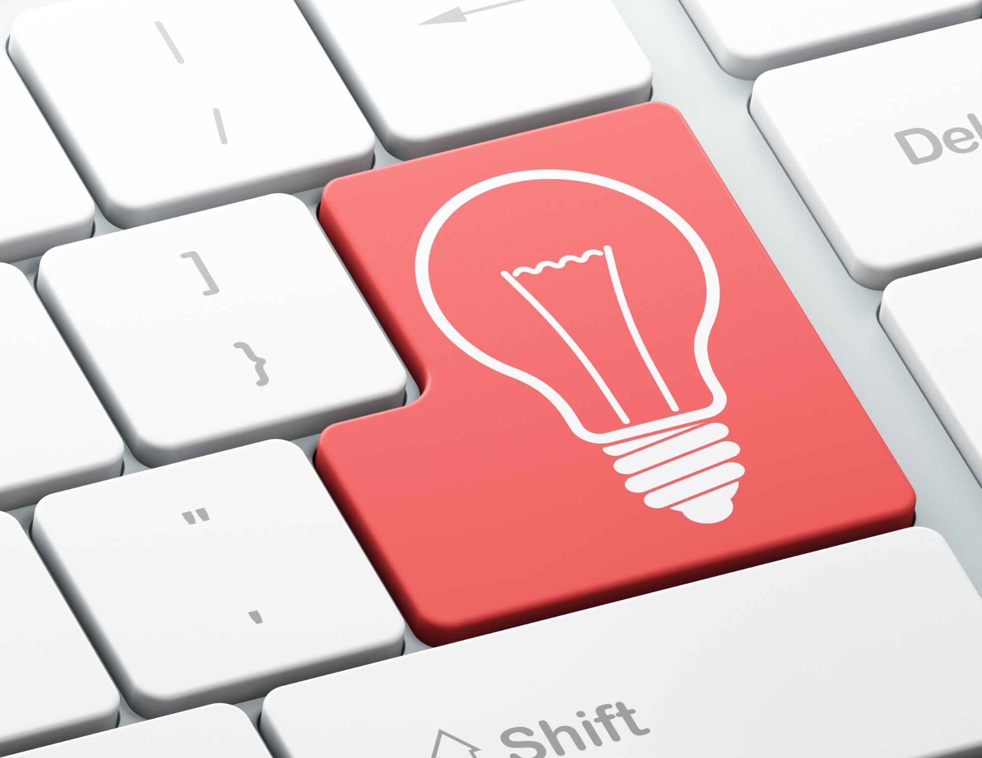 an image of a keyboard where the enter key is bright red and has a lightbulb on it