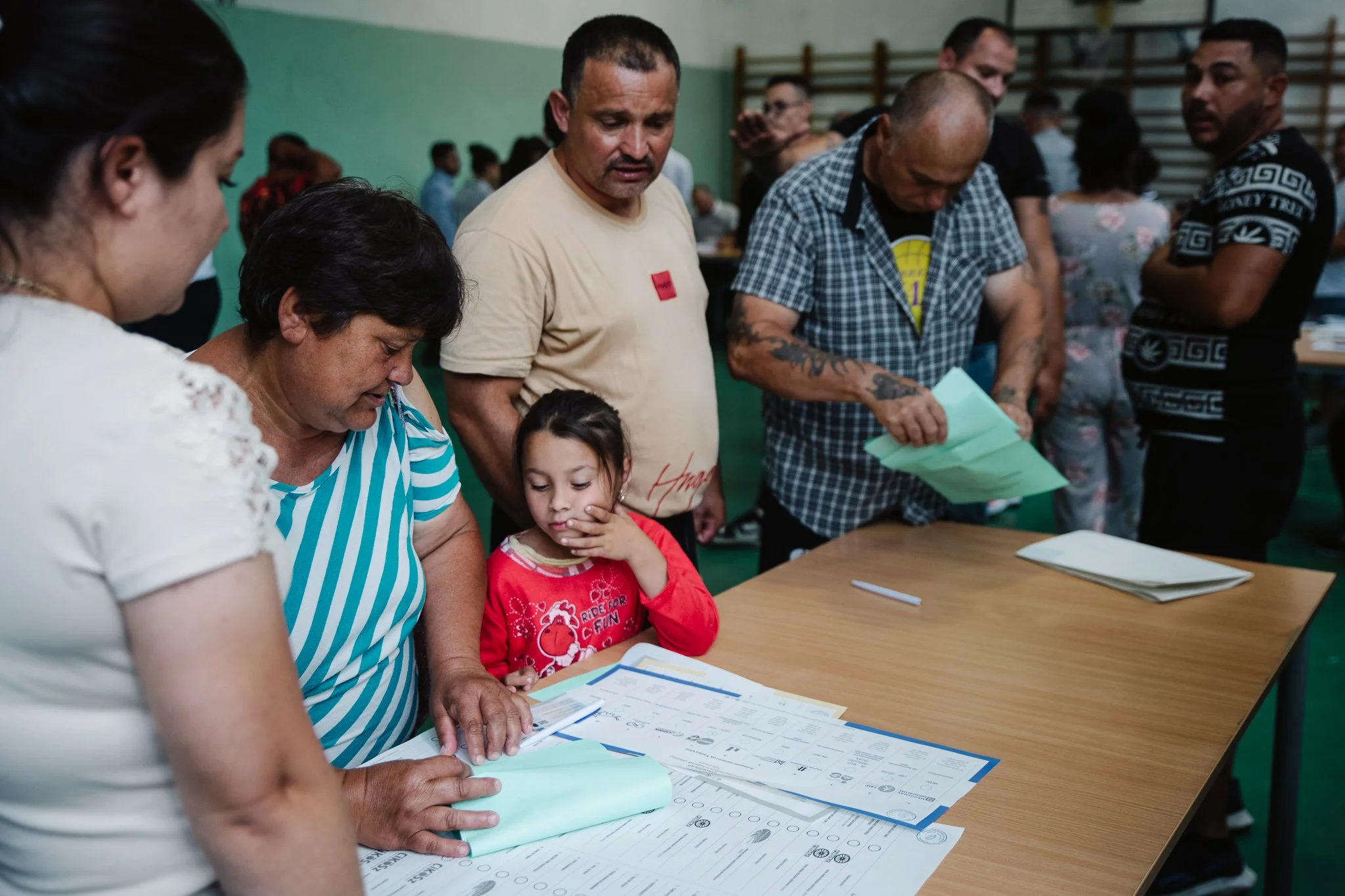 A woman fills in the ballot papers. Many voted in the presence of others, giving those bystanders a chance to have a say in who they voted for. According to some locals all the political formations running offered the same amount of money, 20,000 for