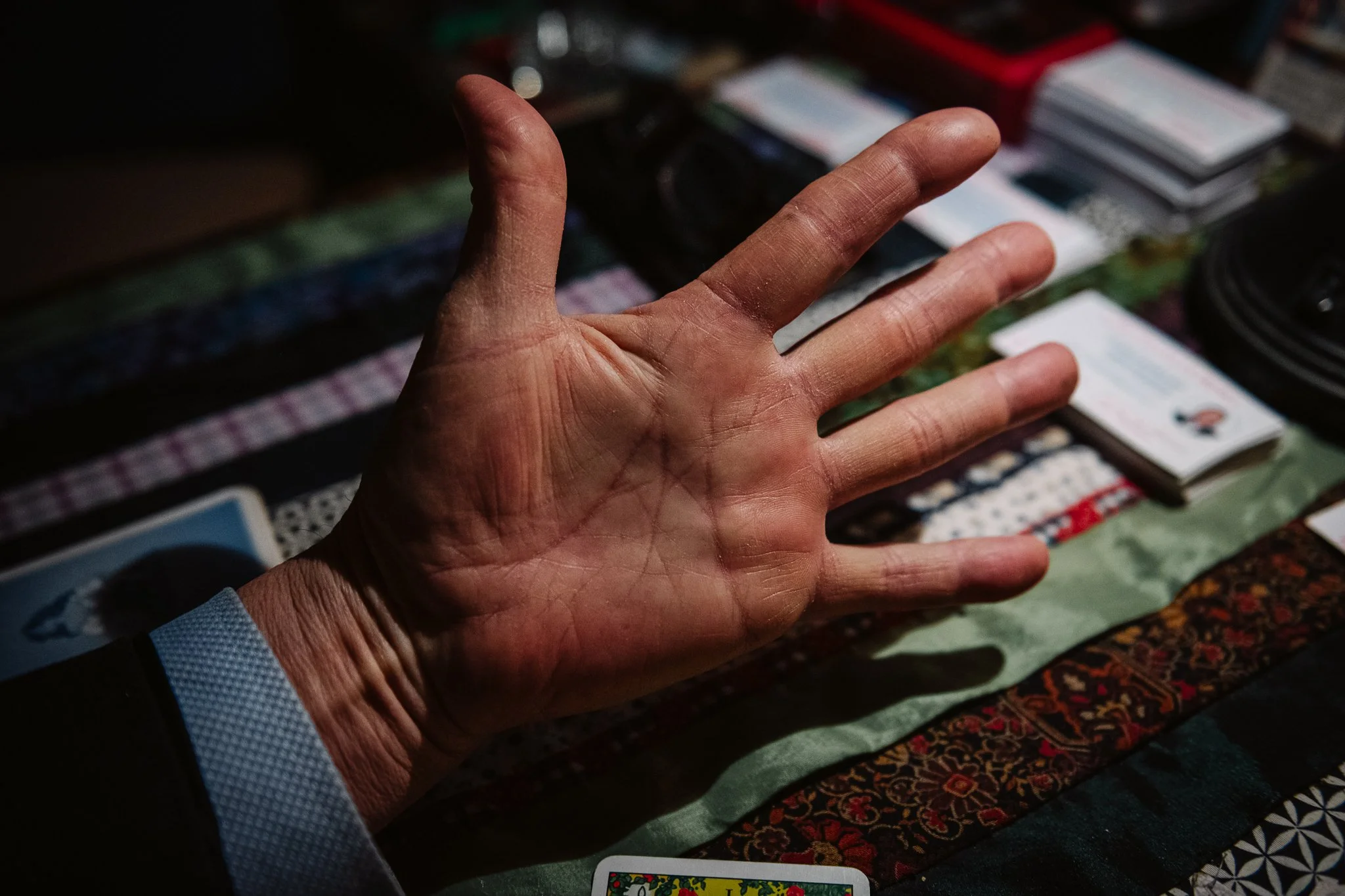 The letter "M" on Lóri's palm. It's one thing to use the magician card, and quite another to be marked by it.