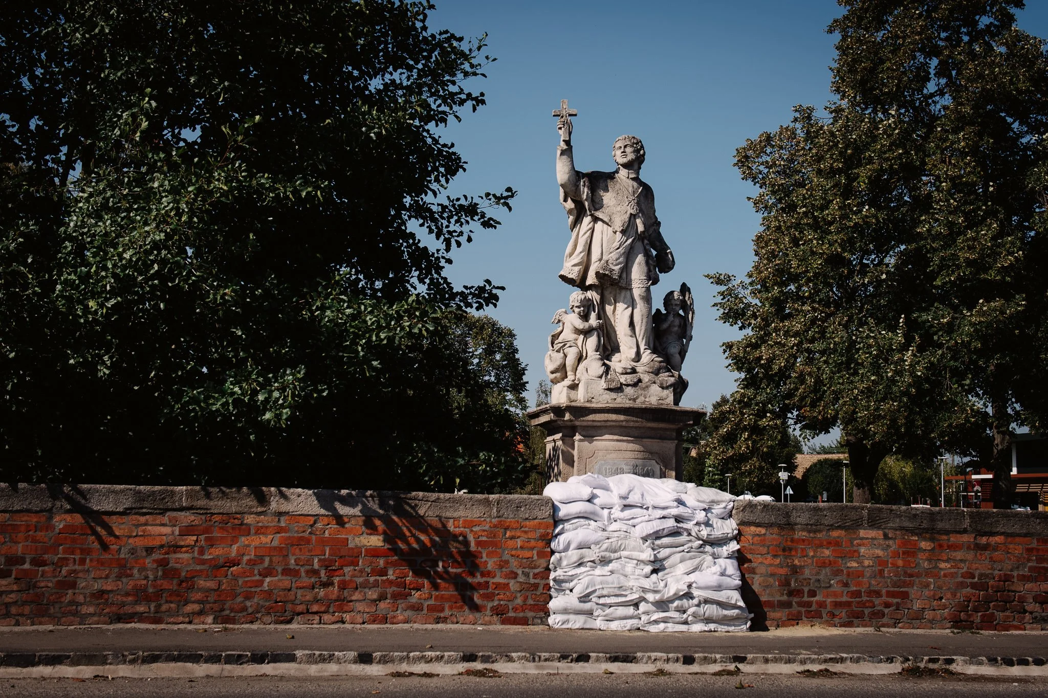 The statue of St. John Nepumuk in Vác, on the bridge over the Gombás stream on 19 September 2024. Colloquially known as Kőhíd or Kőszentes Híd, it is Hungary's oldest road bridge still in use today, built in the 18th century. It is located not far fr