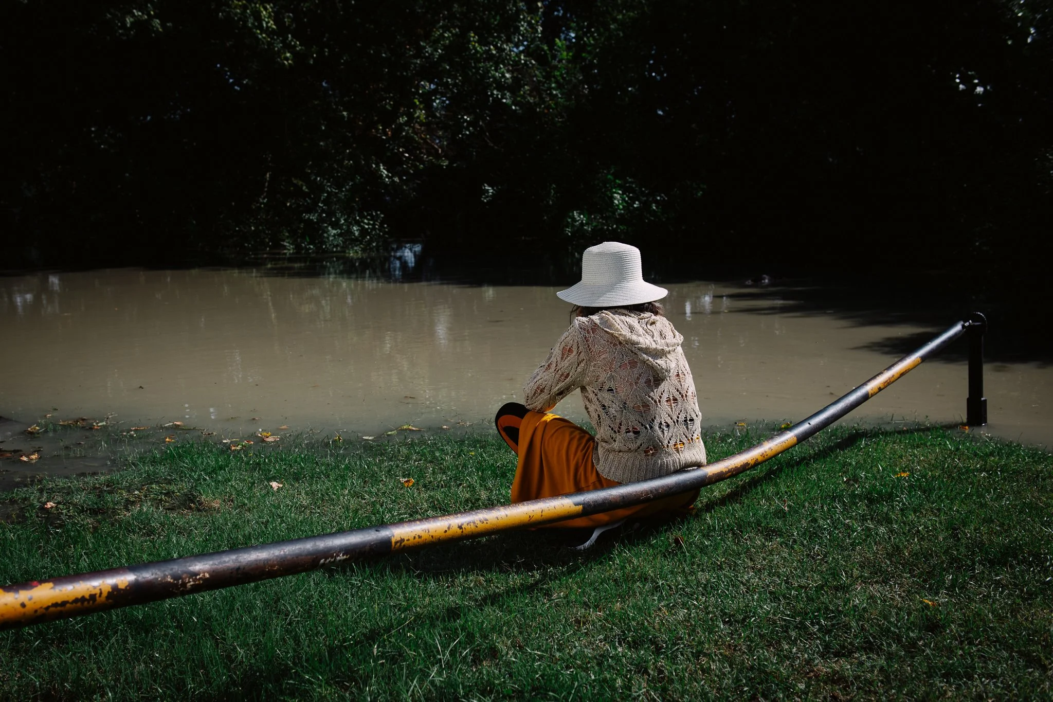 A woman watches water flowing out of the riverbed in Leányfalu on September 18, 2024.