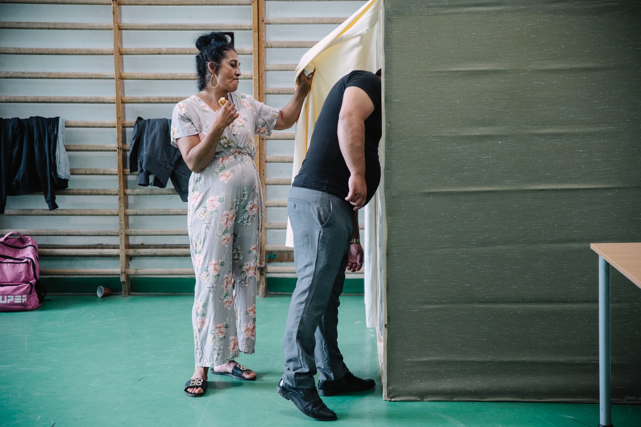 A couple "helps" a voter, presumably to get the X into the right box.