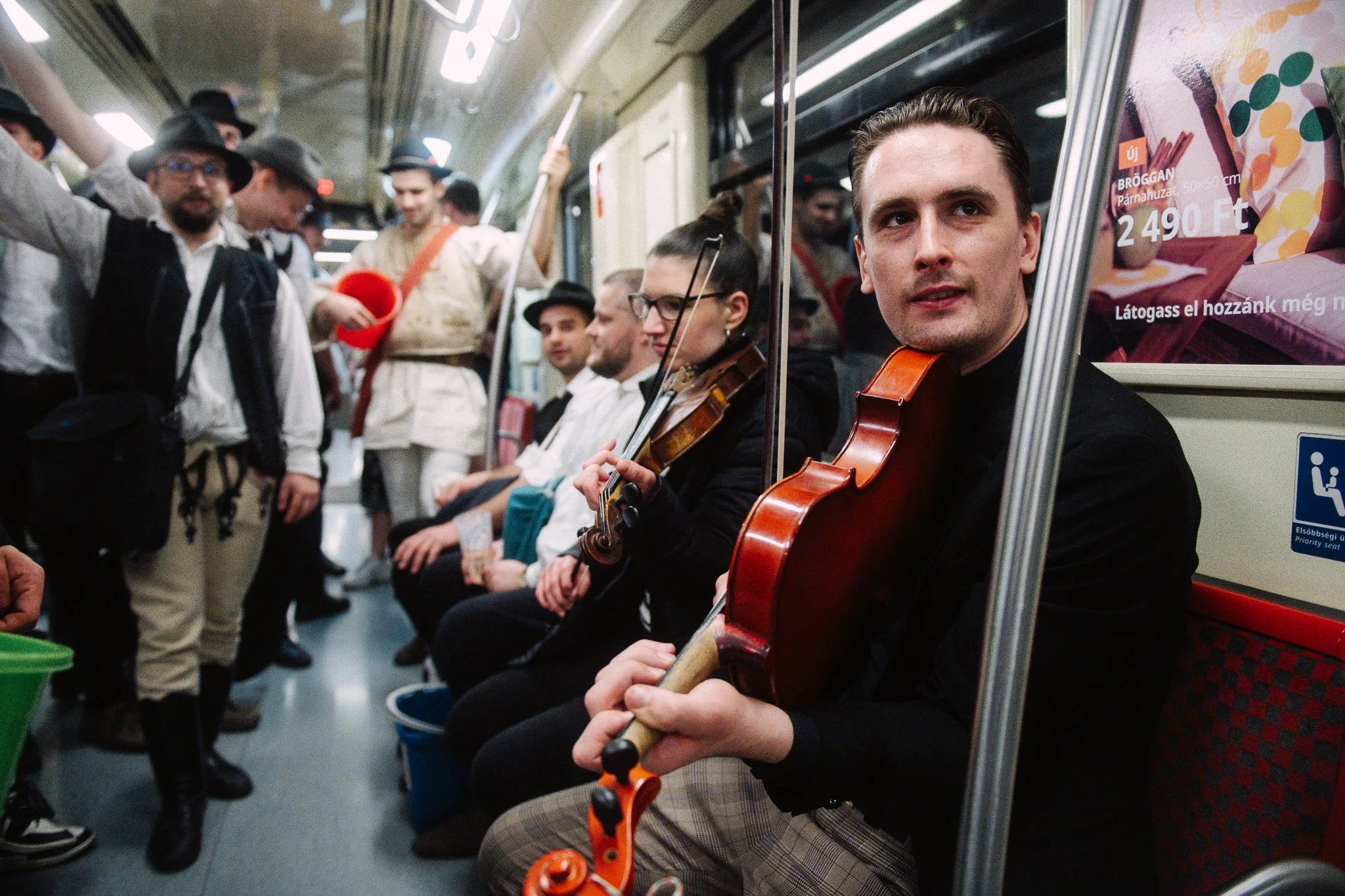 The viola player plays some music
in the train while the others are singing, sometimes even
dancing.
