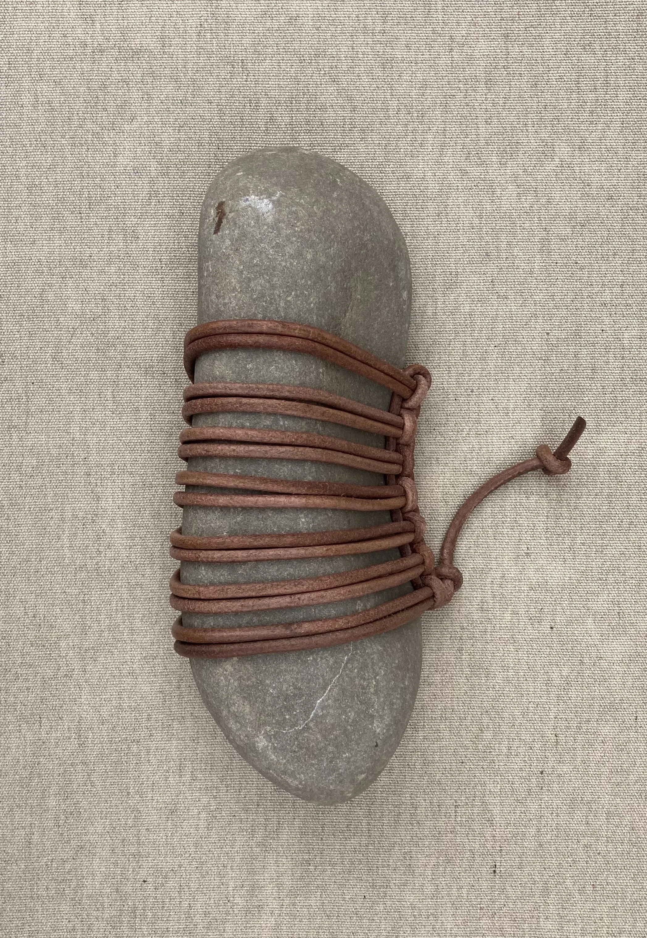 JIM OLARTE  
Large wrapped rock (2025)  
10.5” x 4.5”  
Rock wrapped in leather cord  
$750