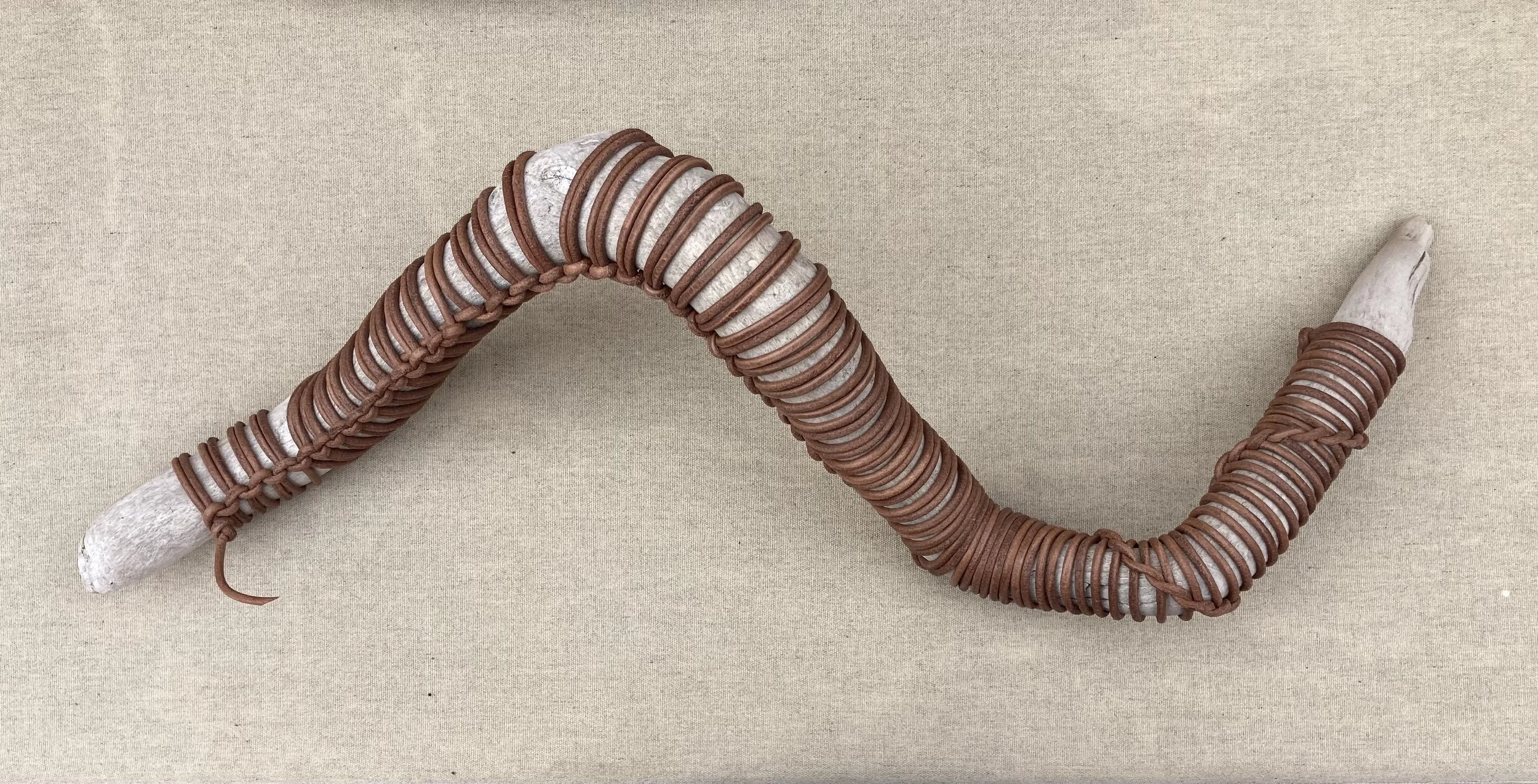 JIM OLARTE  
Wrapped driftwood 2 (2025)  
37” x 13”  
Driftwood wrapped in leather cord  
$995