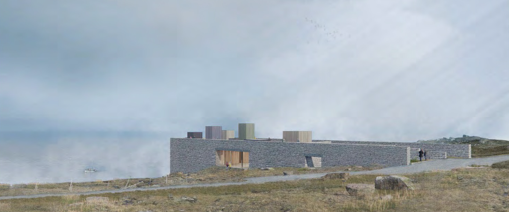 A modern, low-rise building with a stone facade and colorful, rectangular structures on the roof, situated in a natural landscape with grass, rocks, and a cloudy sky.