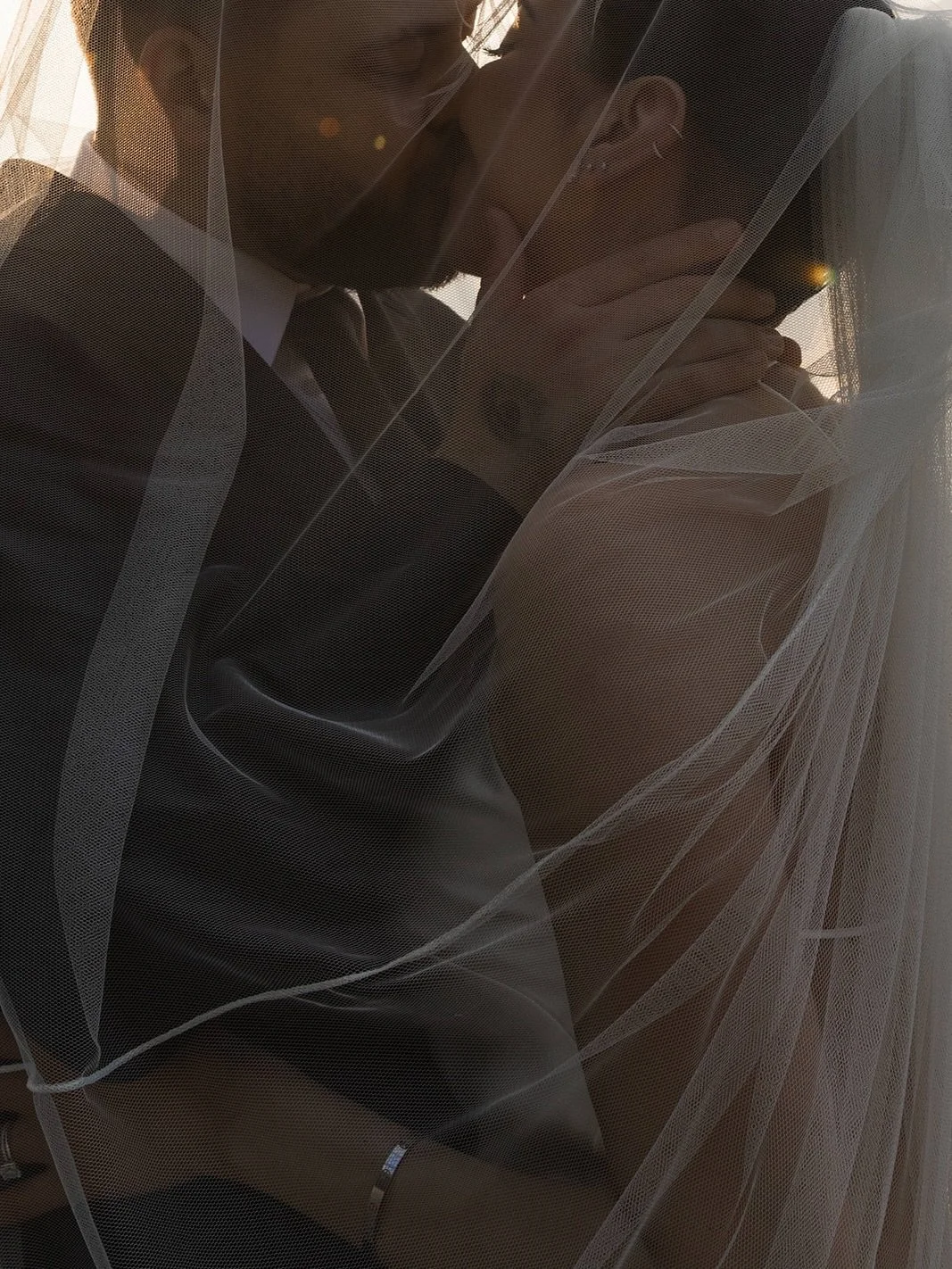 Wedding of Natalie and Malcolm. 

An intimate wedding on Lake Como, centered on a young couple deeply in love.
As the sun begins to set, the lake glows warm and luminous, wrapping them in golden light.
A boat drifts gently across the water &mdash; ju