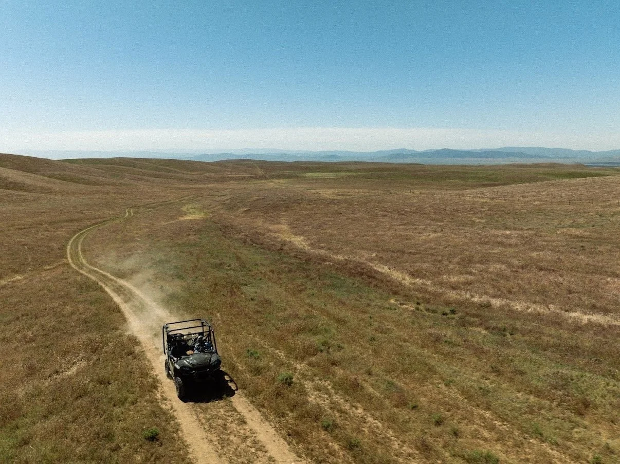 Driving through open grasslands at Carissa Plains Outfitters, covering miles of Central California hunting terrain