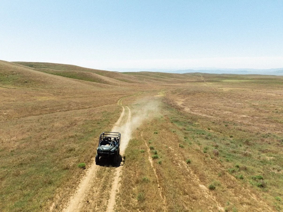 A lone UTV cuts across endless rolling hills, kicking up dust as the hunt unfolds across Carissa Plains