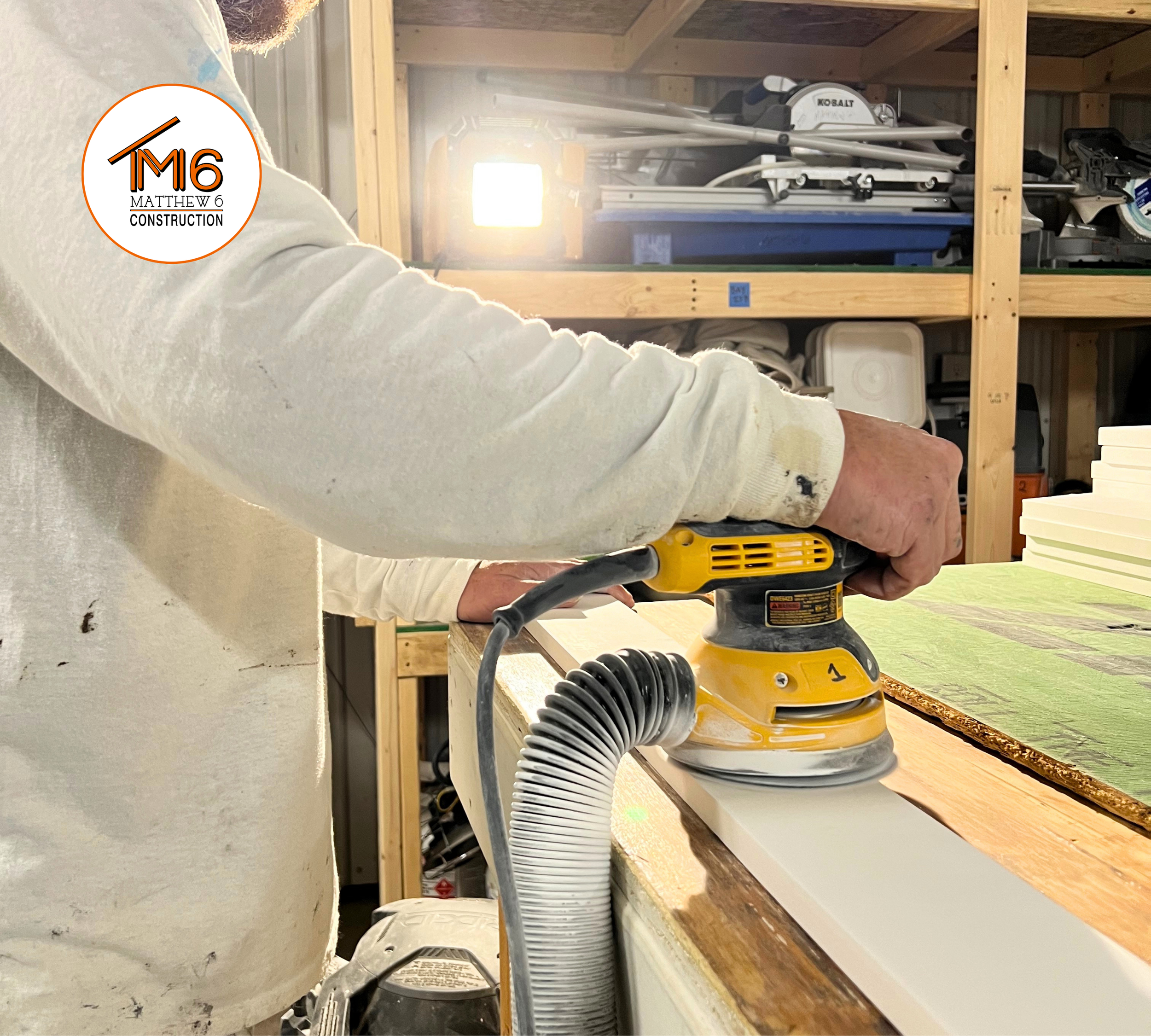 Tim from Matthew 6 Construction sanding trim as part of interior finish carpentry