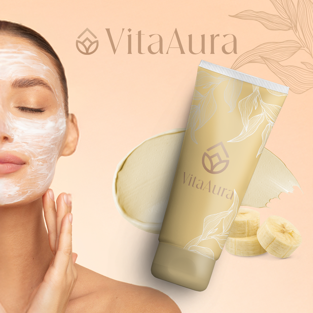 A woman with a face mask near her cheek, with a tube of VitaAura skincare product, banana slices, a cream or lotion, and a leaf design on the packaging. The background is soft beige with a leaf illustration and the VitaAura logo.