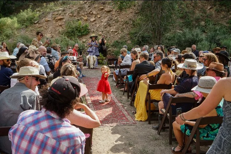 Outdoor wedding ceremony in Utah with guests seated surrounded by nature