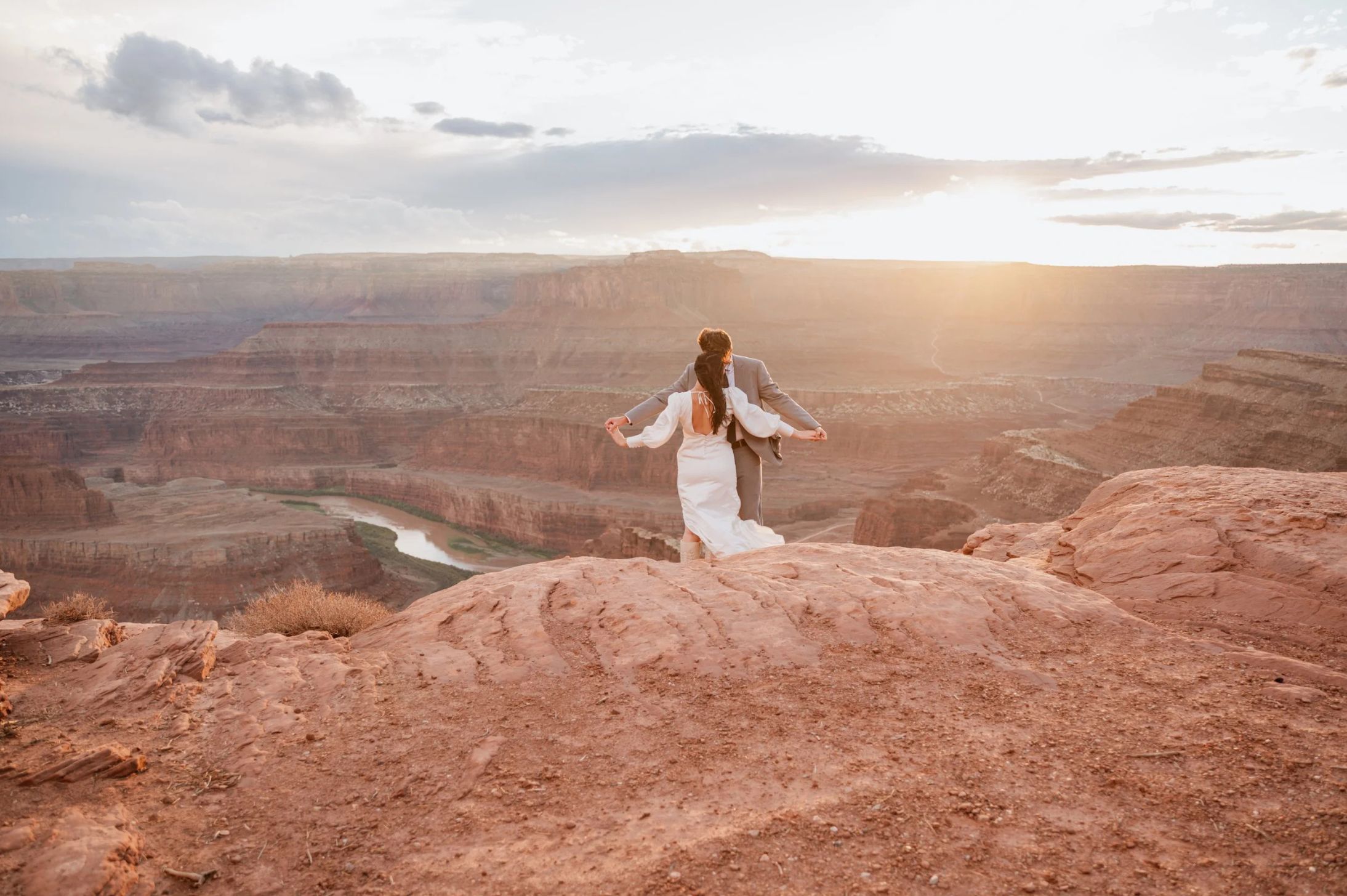 Newlyweds at sunset during Utah desert elopement ceremony red rock landscape