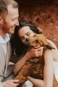 Newlyweds celebrating after Utah desert wedding ceremony with their dog
