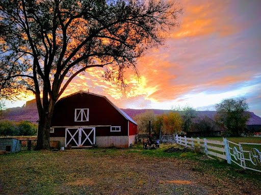 Our Village rustic barn wedding venue in Moab Utah at sunset