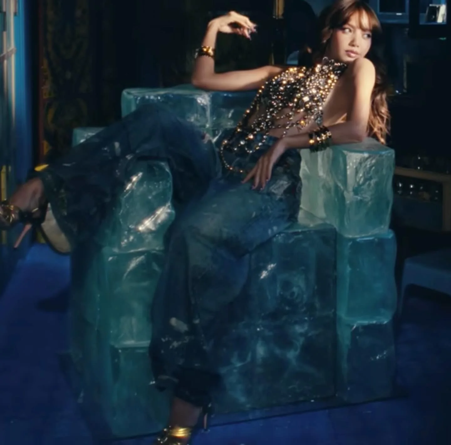 Lisa  Manoban from pop group black Pink sits in a faux ice block chair we created for her music video.