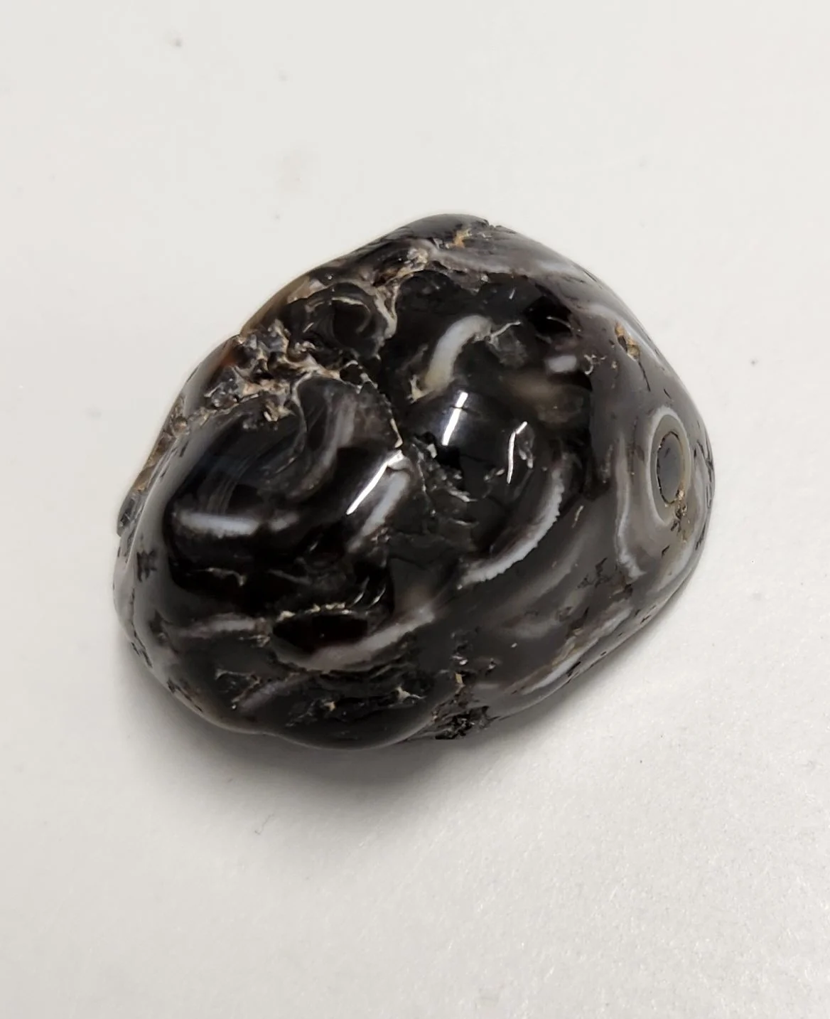Enhydro agate crystal with visible water bubble inclusion inside banded agate, used for emotional grounding, intuition, and ancient Earth connection