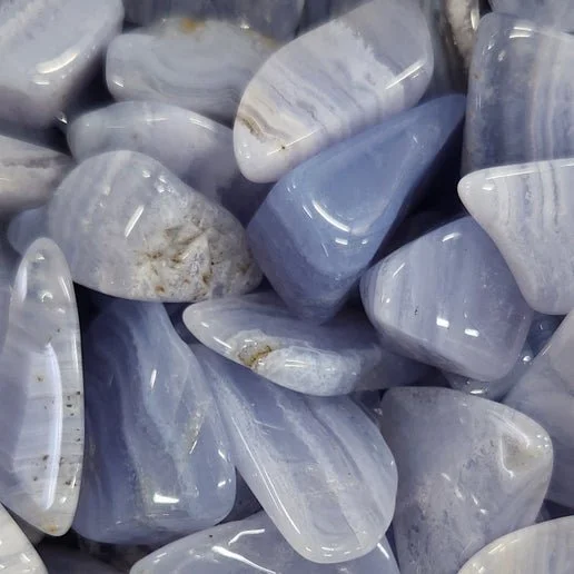 Blue Lace Agate stone showing soft pale blue banding with delicate white lace-like patterns and a smooth, polished surface.