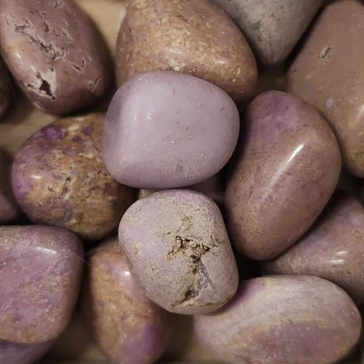 Soft lilac phosphosiderite crystal in rough and tumbled forms with gentle natural sheen.