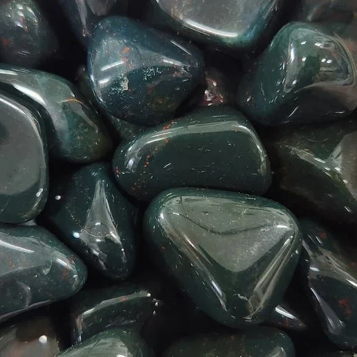 A Bloodstone crystal with deep green colouring and distinctive red speckled inclusions, polished smooth.