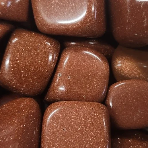 Goldstone polished stone displaying rich coppery sparkle throughout deep golden-brown glass.