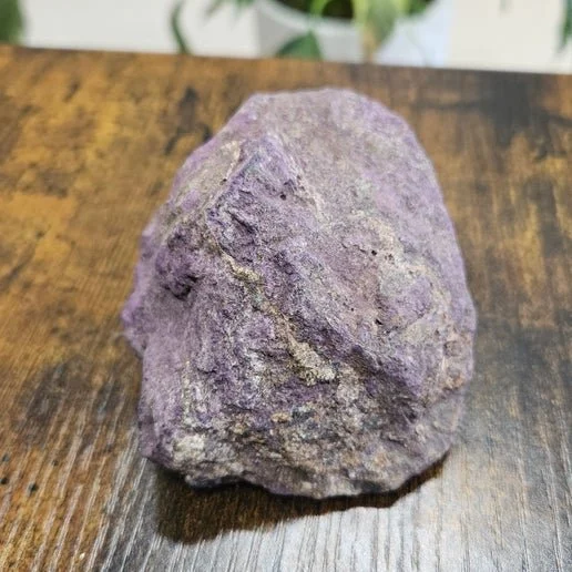 Deep purple purpurite mineral specimen with matte texture used for throat chakra activation and spiritual awakening.
