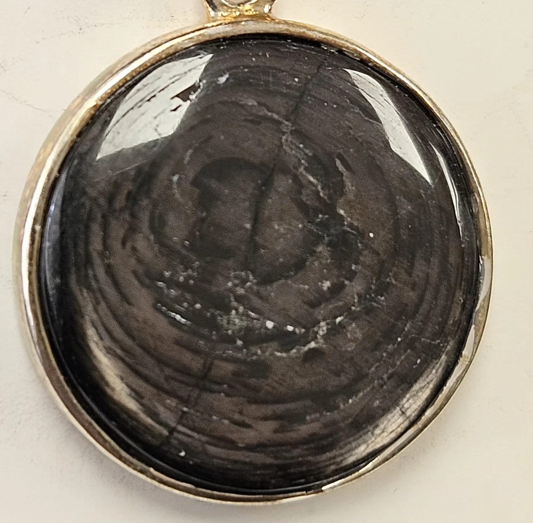 Dark hypersthene tumbled stone with silver sheen used for grounding, mental clarity, and intuitive balance.