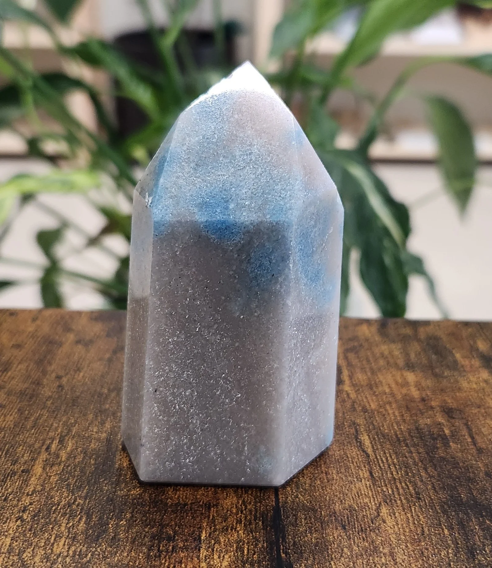 Polished blue and white Trolleite stone with soft marbled patterns and quartz matrix.