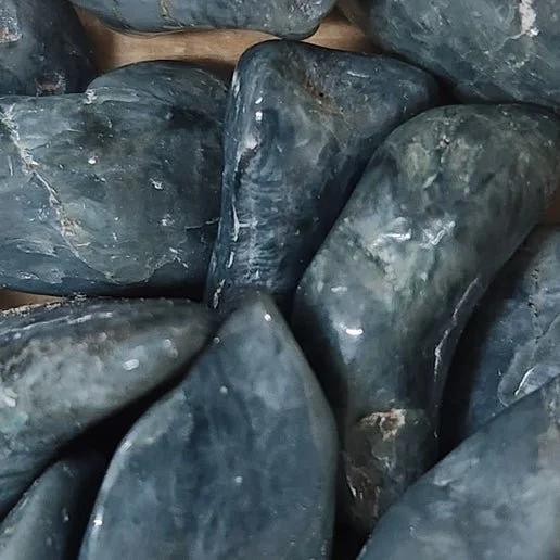 Soft blue Blue Jade stone displayed in polished and natural forms with smooth calming tones.
