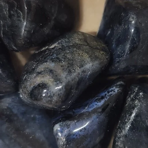Deep blue Dumortierite crystal showing fibrous texture in raw stone and quartz-hosted formations.