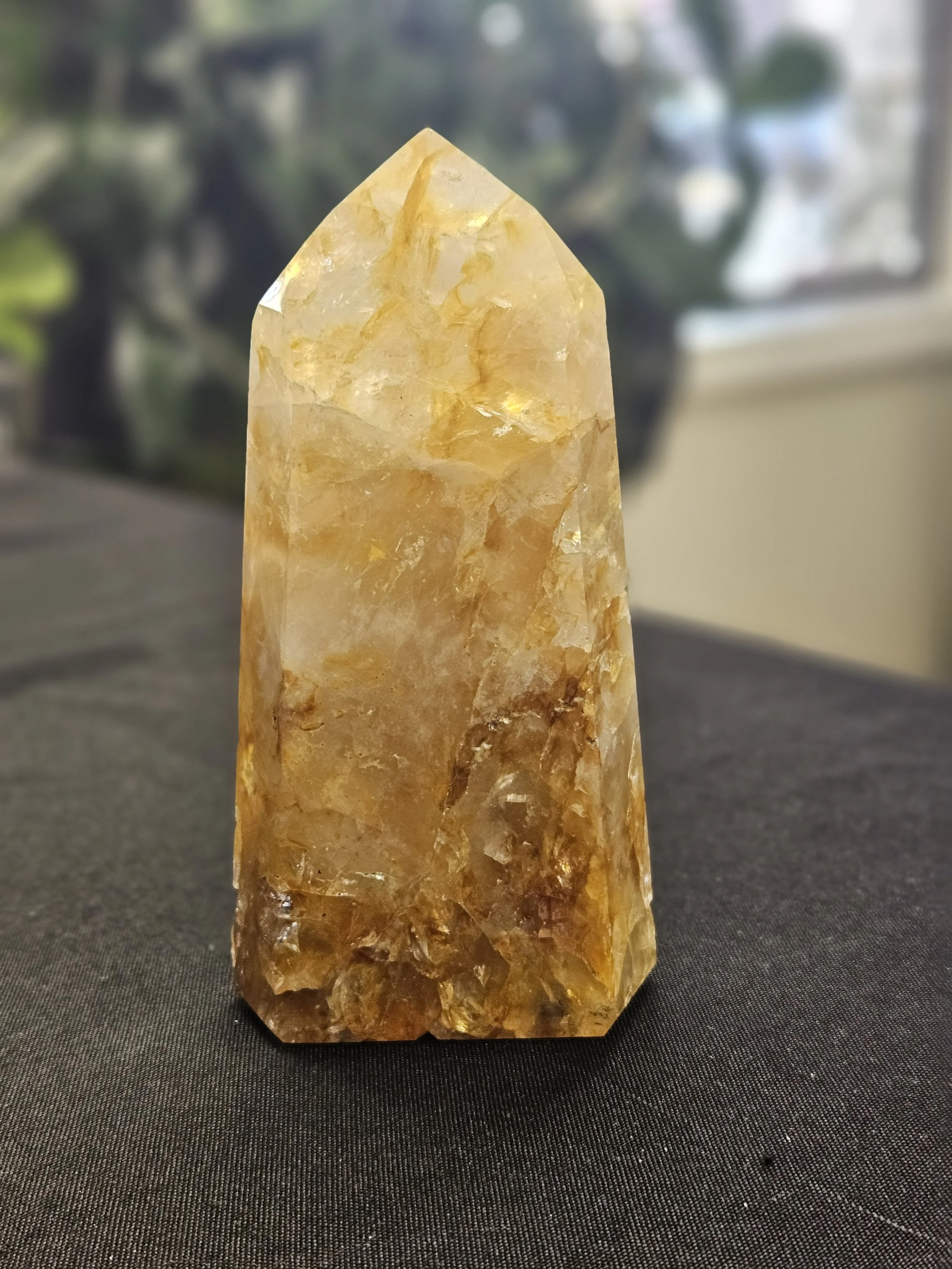 Golden Healer Quartz crystal showing warm golden-yellow iron inclusions within clear quartz structure.
