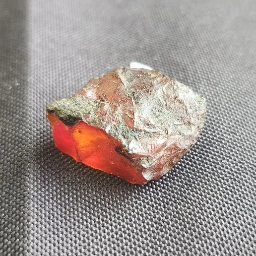 Baltic Amber stone with warm golden-orange tones, showing natural translucency and smooth polished texture.