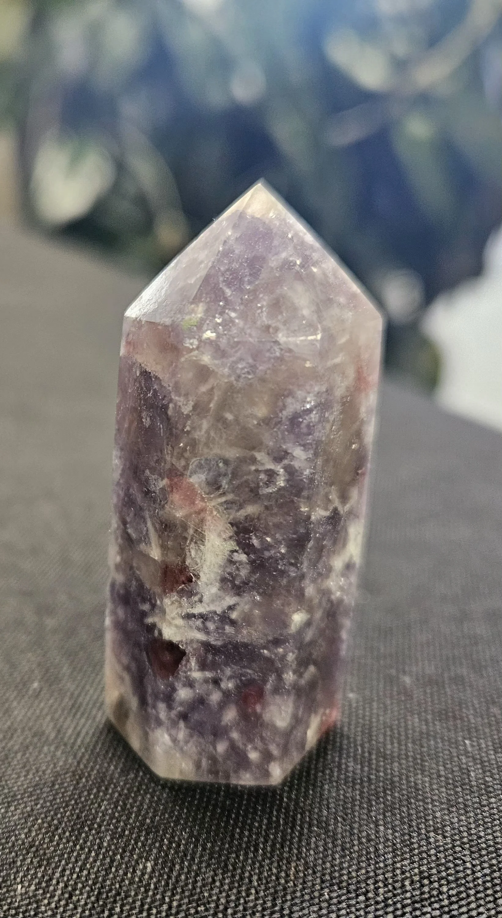 Unicorn Stone showing pink, lilac, white, and smoky tones in a polished and rough mixed mineral stone.