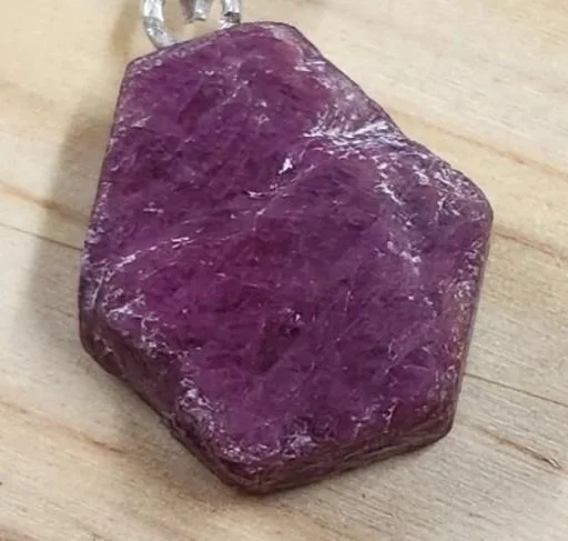 Deep red natural ruby crystal in matrix used for vitality, courage, and heart-root chakra activation.
