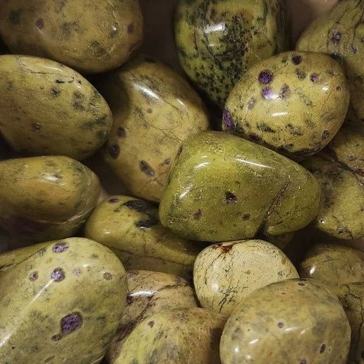 Atlantasite stone showing mottled green and soft purple colouring, with a smooth polished surface and natural blended mineral patterns.