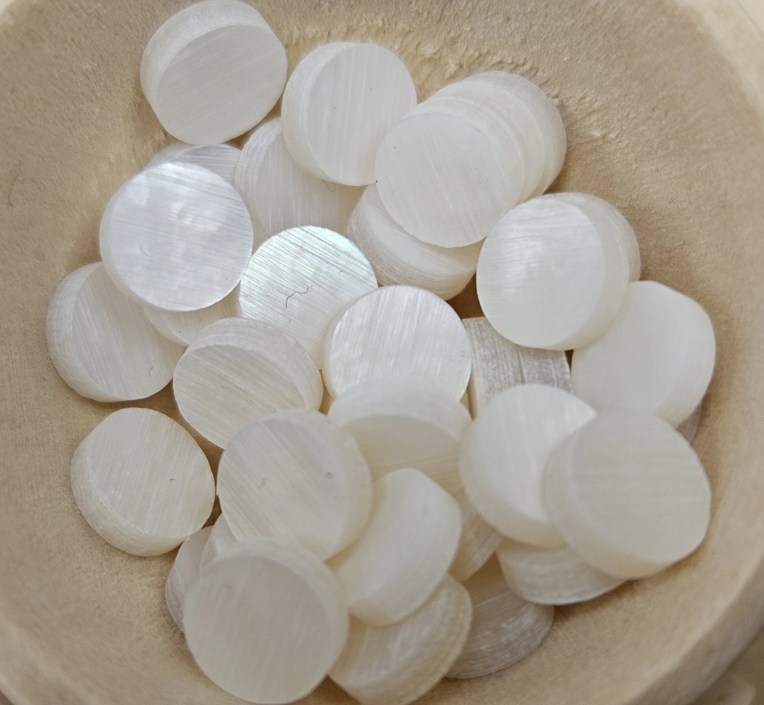 Iridescent Mother of Pearl shell interior with soft rainbow sheen and polished pieces.