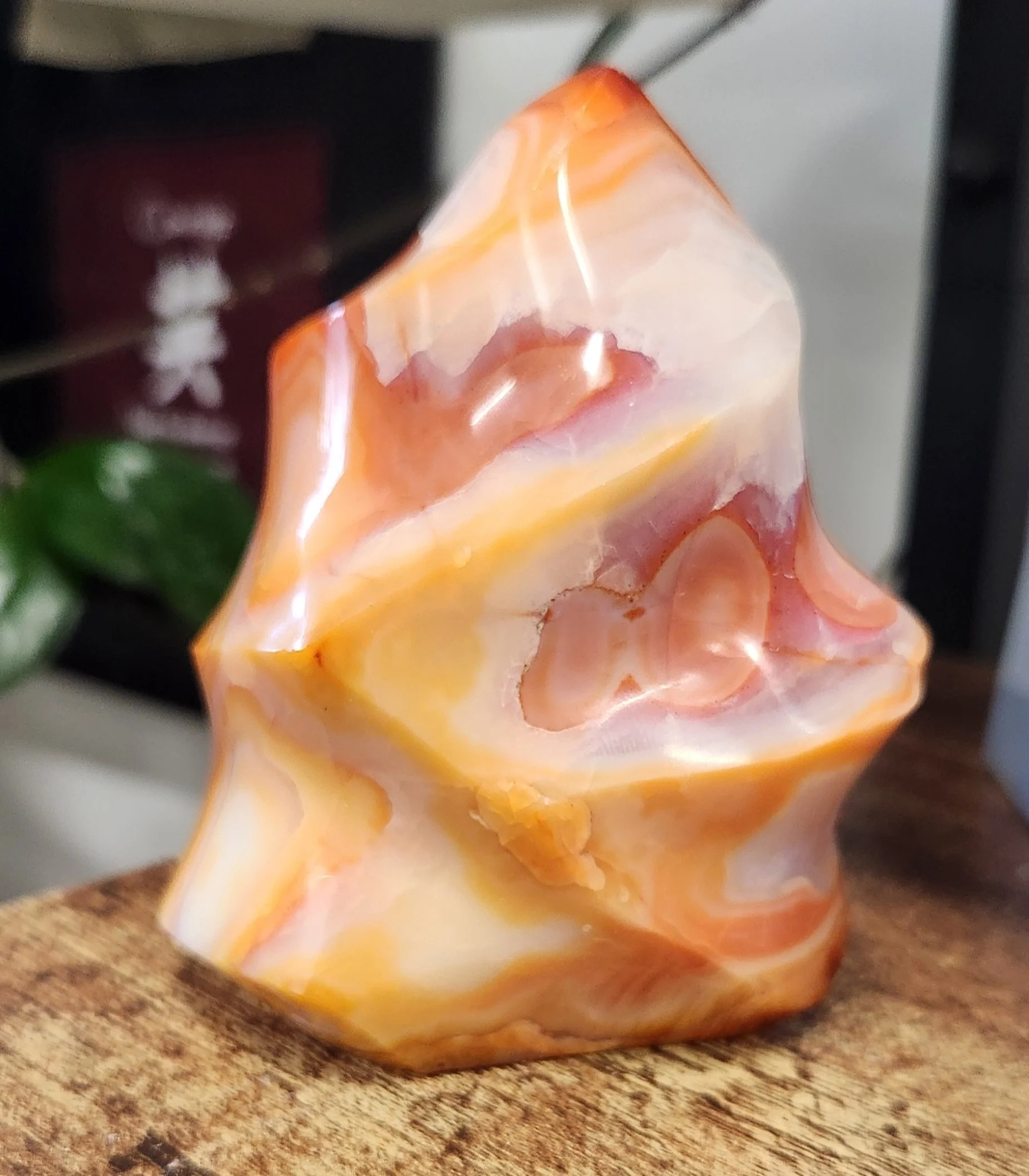 Carnelian crystal displaying warm orange to reddish tones with a smooth, polished surface and vibrant energy.