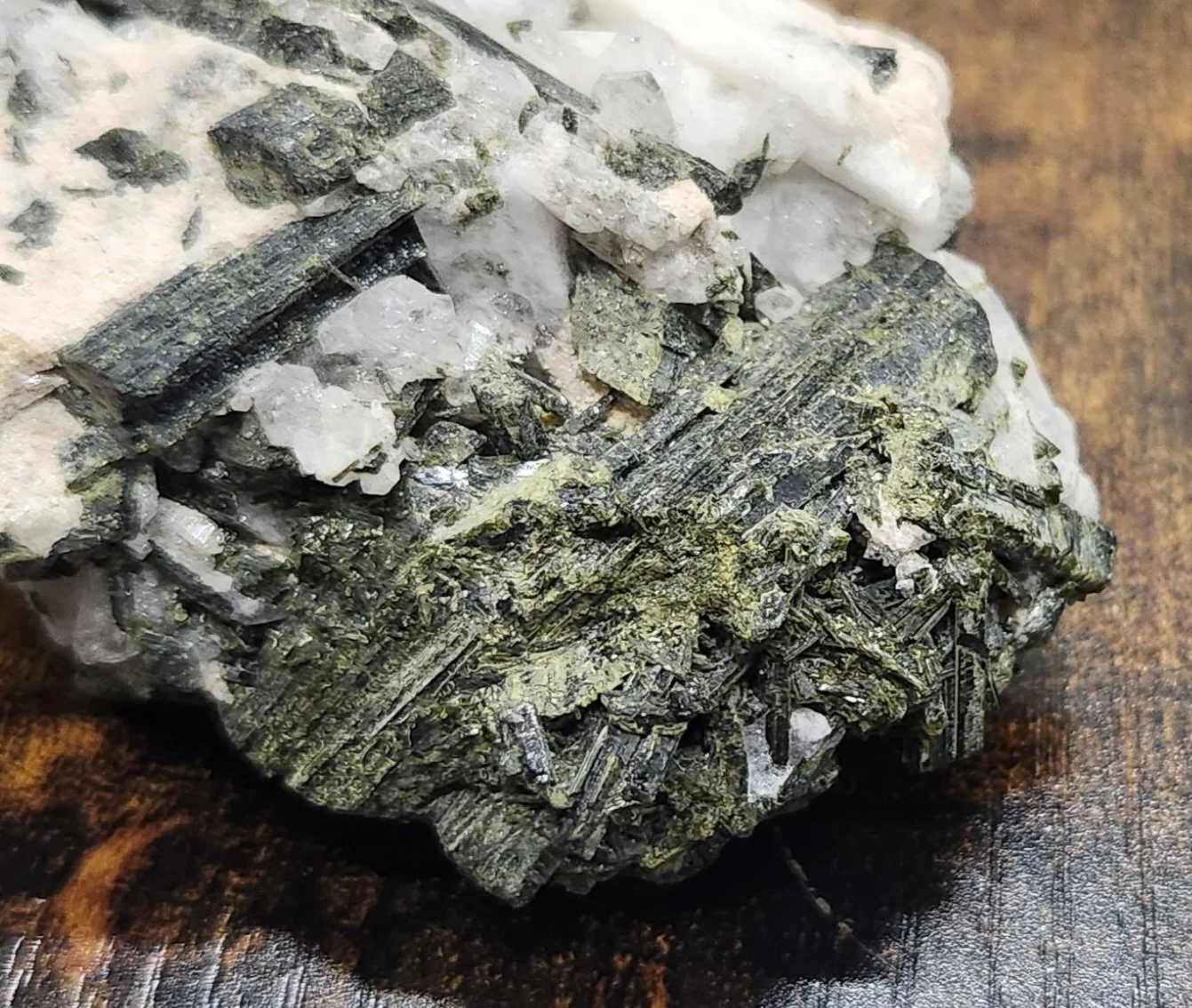 Raw green epidote crystal specimen with natural texture and earthy mineral formation used for spiritual growth and manifestation practices