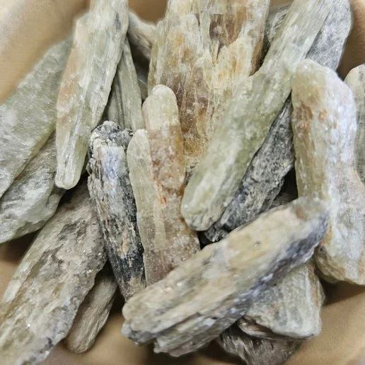 Natural Green Kyanite blade crystal with soft green tones and visible striations in raw formation.