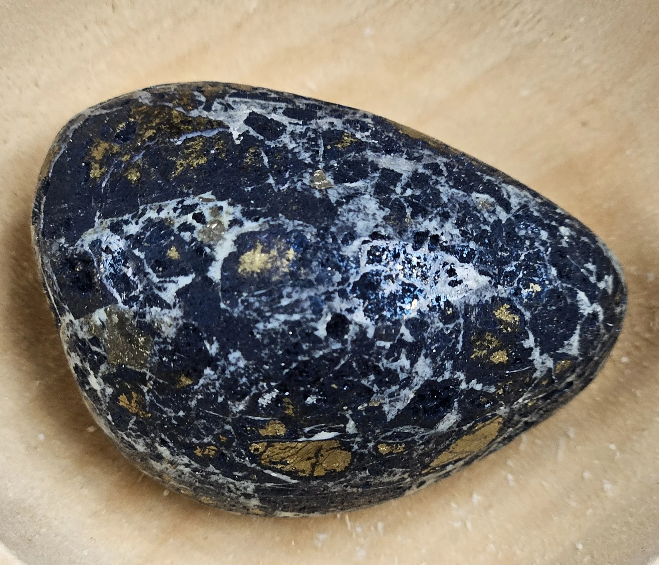 Covellite mineral showing deep indigo-blue tones with subtle iridescent sheen and natural metallic texture.