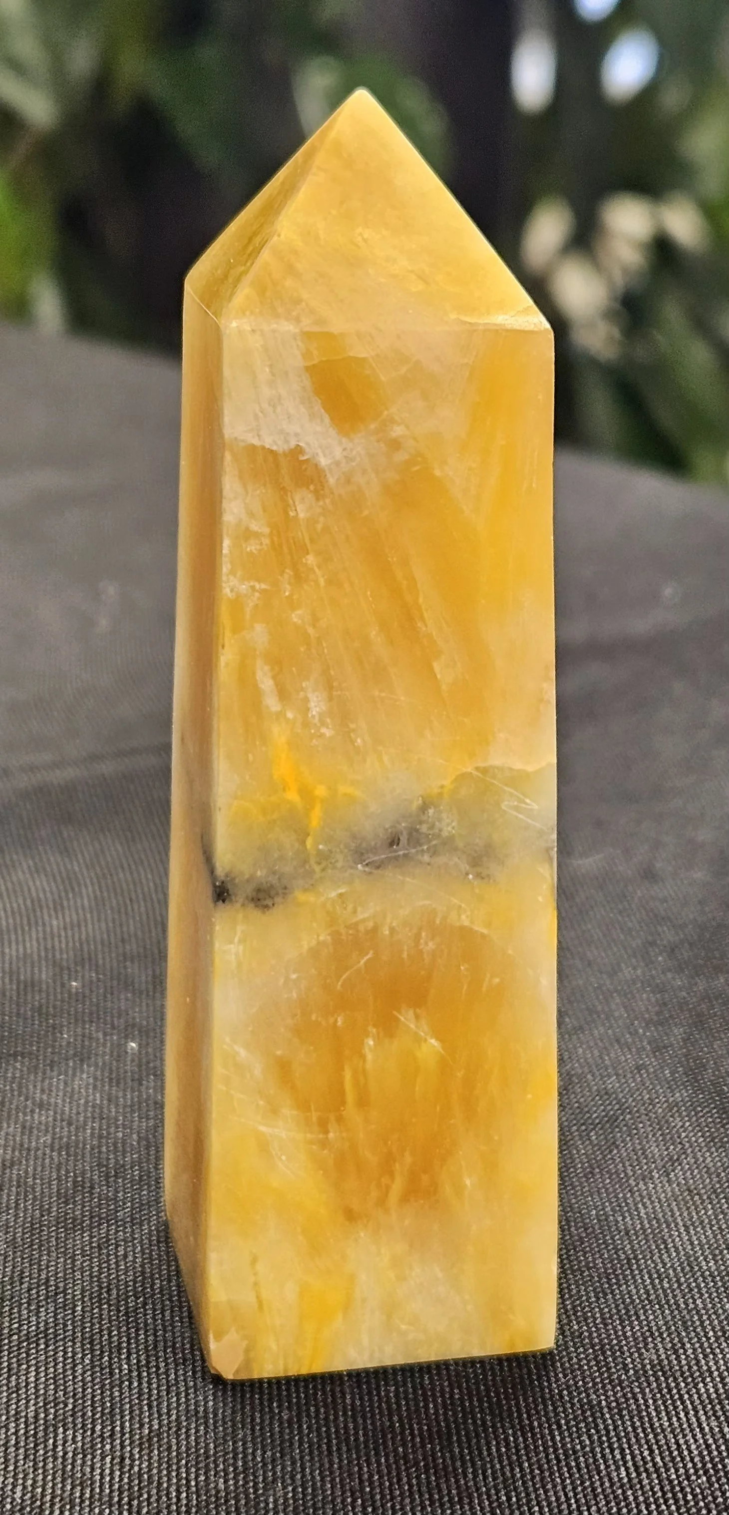 A Bumble Bee Jasper stone with striking bands of yellow, orange, and black in bold, natural patterns.