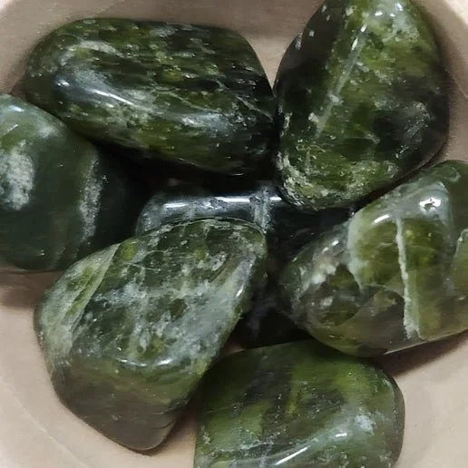 Green Vesuvianite crystal specimen, also known as Idocrase, in rough and tumbled form.