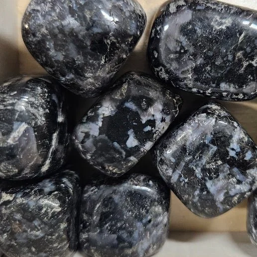 Mystic Merlinite Indigo Gabbro stone showing dark black and grey tones with subtle indigo flashes.