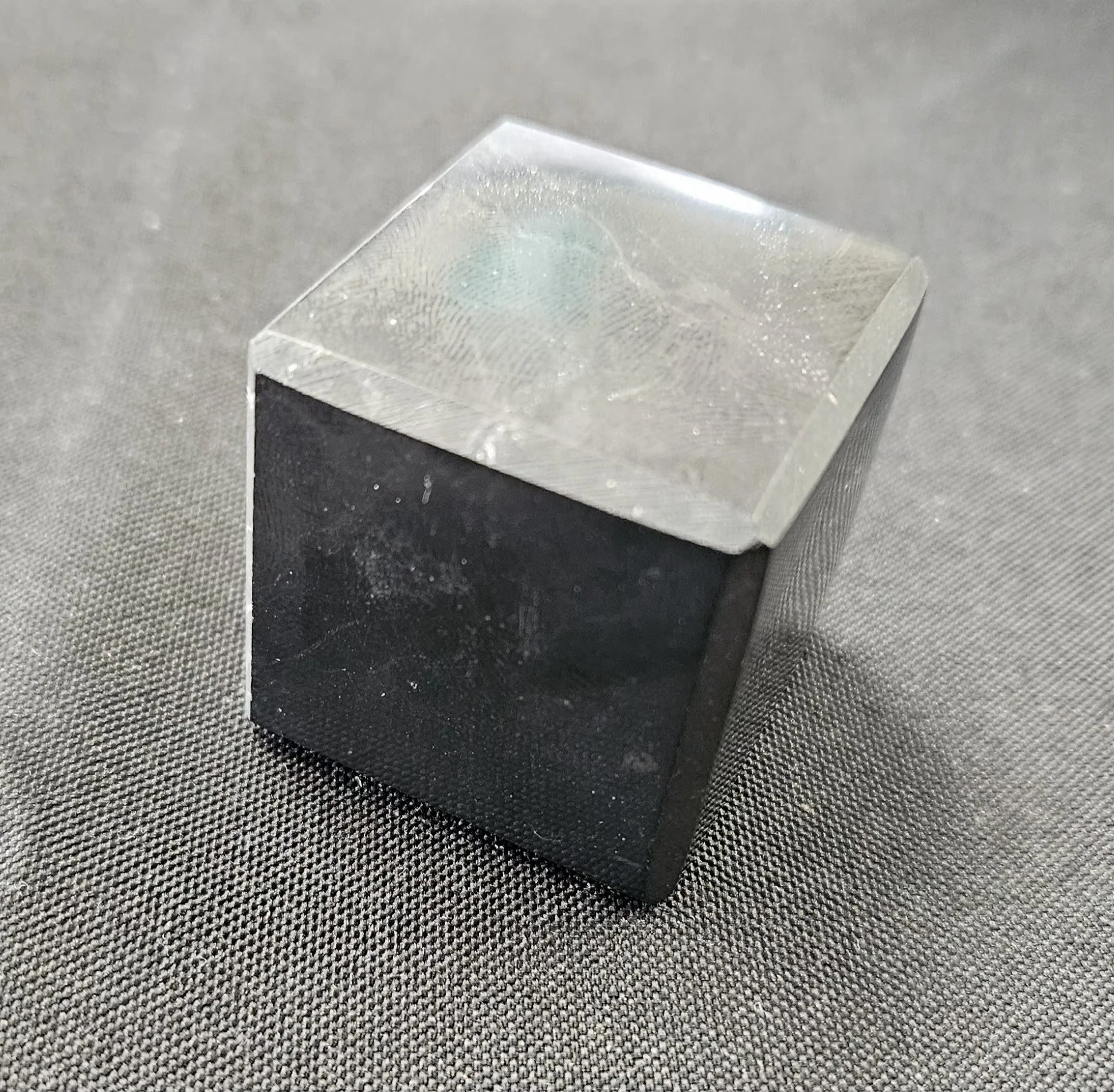 Raw and polished black Shungite stones, including a tumbled piece and a pyramid shape.