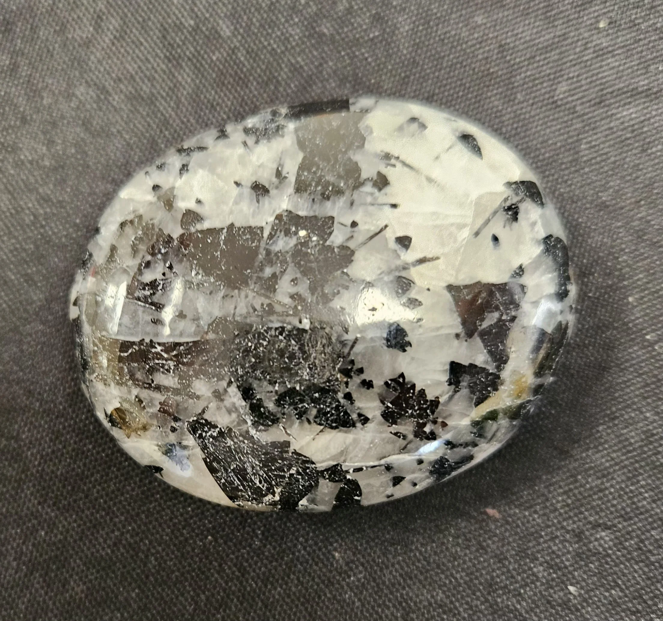 Clear quartz crystal with natural black tourmaline needle inclusions running through the stone.