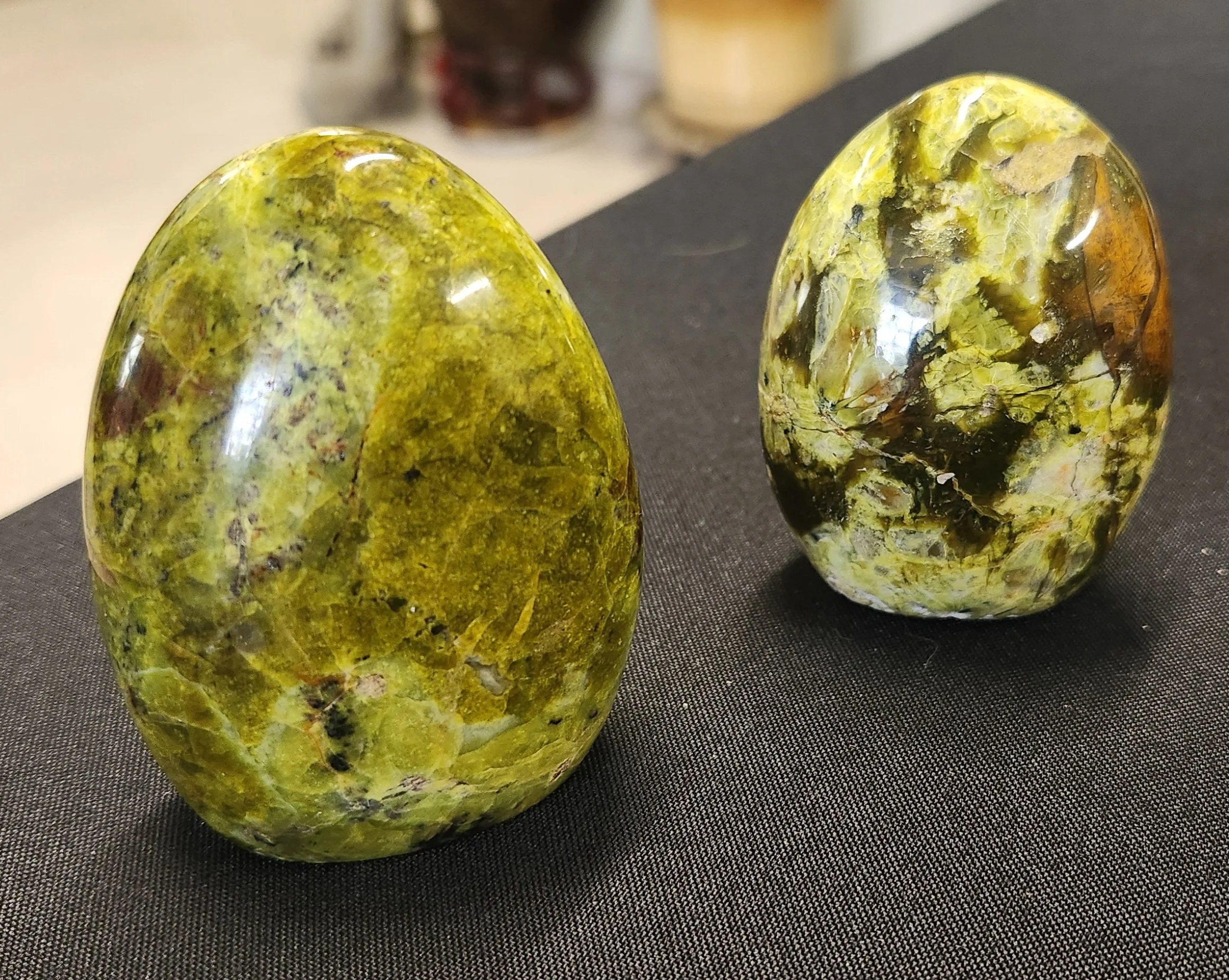 Soft green Green Opal stones shown in raw and polished forms with smooth calming tones.