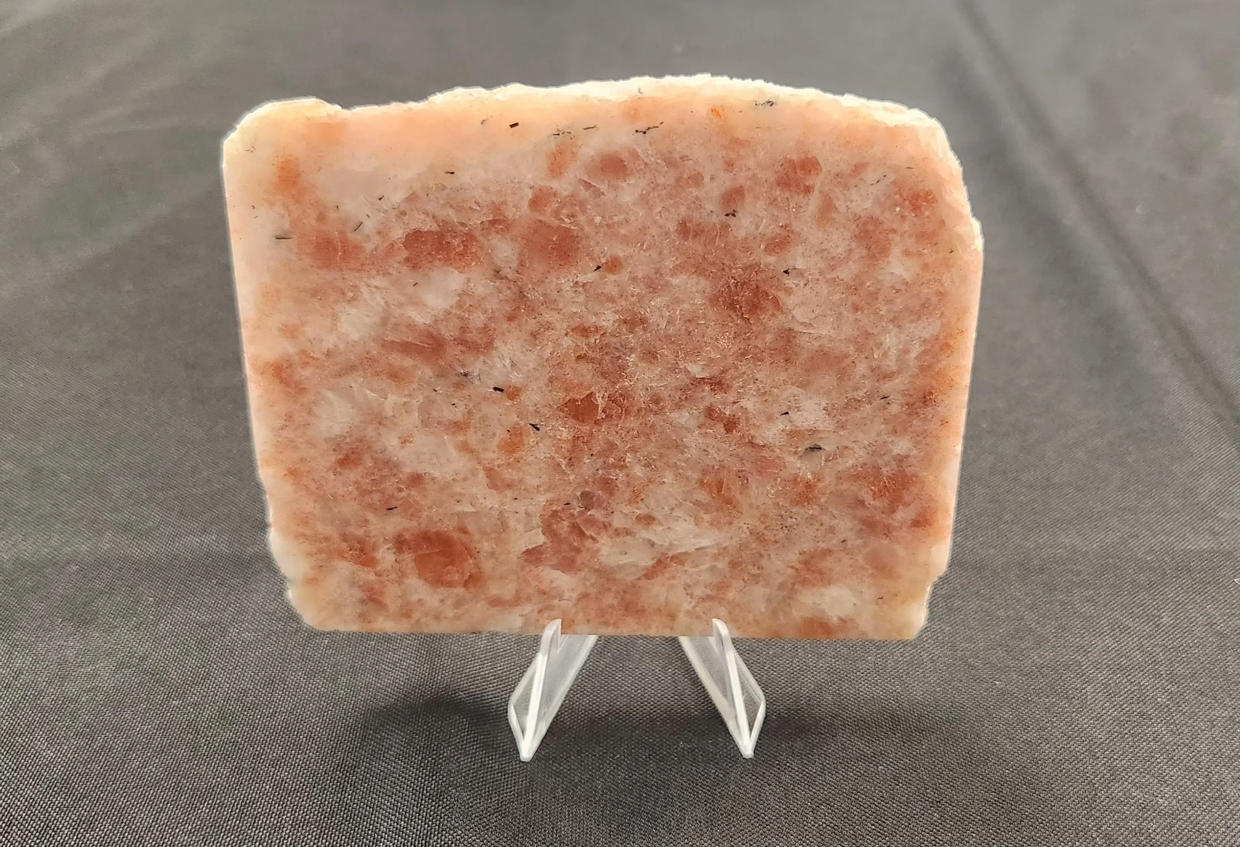 Orange Sunstone gemstone with natural coppery sparkle and polished tumbled form.